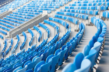 Naklejka premium Rows of blue seats at football stadium. Convenient sitting for all