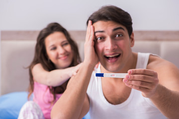 Young family with pregnancy test results