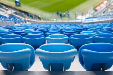 Rows of blue seats at football stadium. Convenient sitting for all
