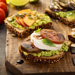 Variety of avocado toasts on a cutting board
