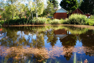 Fototapeta na wymiar Counrtyside lake with dramatic reflections background