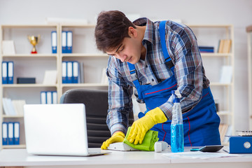 Male cleaner working in the office