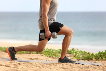 Lunge leg workout with dumbbells weights. Fitness man doing lunges training legs on beach summer...
