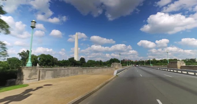 A forward perspective driving on Independence Avenue near the Washington Monument in DC on a sunny summer day.  	