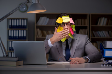 Businessman staying late to sort out priorities
