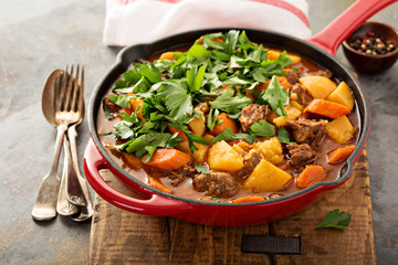 Stewed beef with potatoes, carrot and parsley