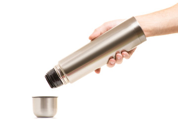 Thermos with a cup in men's hands