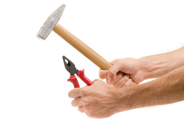 Hammer and pliers in the hands