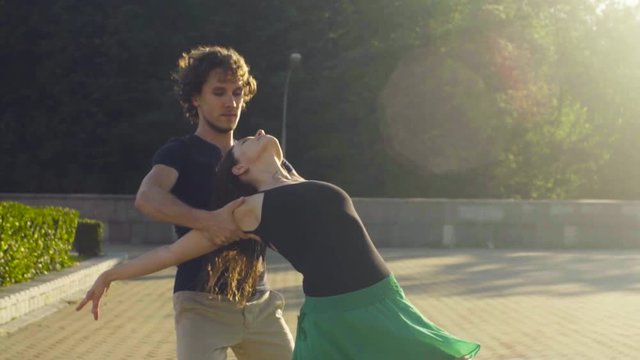 Young couple dancing on the square