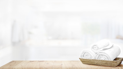 Towels in basket on top wood table with copy space on blurred bathroom background. .Products...
