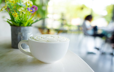 coffee with milk foam topping on white table