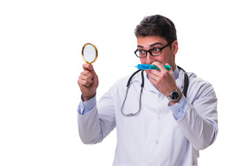 Young doctor with a magnifying glass and a syringe isolated on w