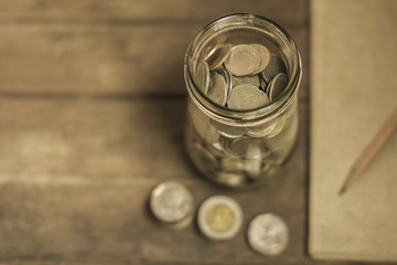Concept of saving money by collecting coins in a glass jar. Money Thailand.