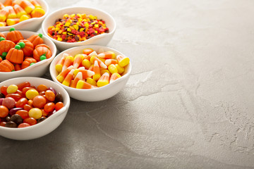 Halloween candy and sprinkles in white bowls