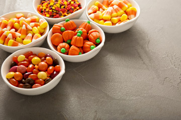 Halloween candy and sprinkles in white bowls