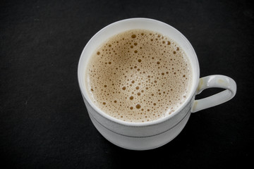 Tea with in a mug or popularly known as Teh Tarik isolated in white view from top.