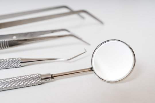 Close up view on dental instruments on white background.