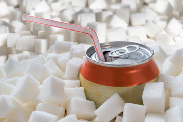 Carbonated soda drink with many sugar cubes. Unhealthy eating concept.