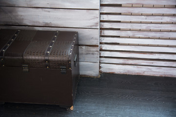 Leather old chest standing on the floor against