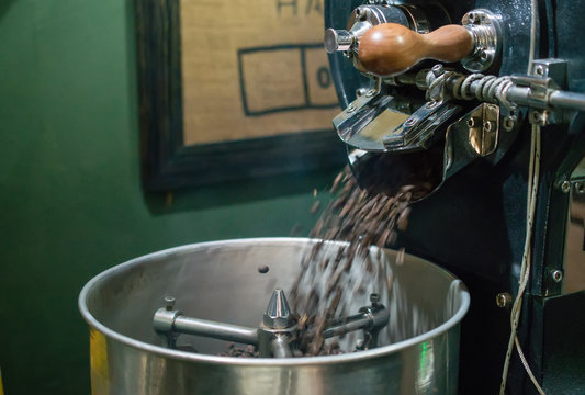 Arabica coffee beans in coffee machine roasting process.Coffee roasters machine. roasted coffee beans in spinning cooler professional machine