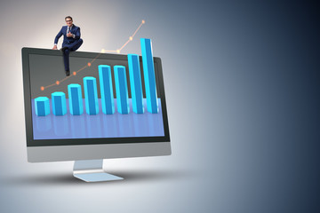 Businessman in economic forecasting concept with charts