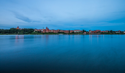 Naklejka na ściany i meble Grudziadz at night with Wisla river, Poland