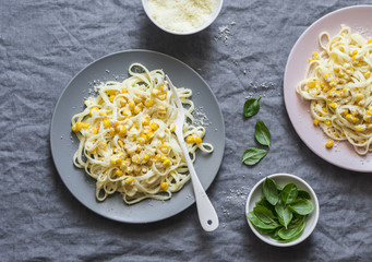 Creamy corn pasta. Linguine with creamy corn on a gray background, top view © okkijan2010
