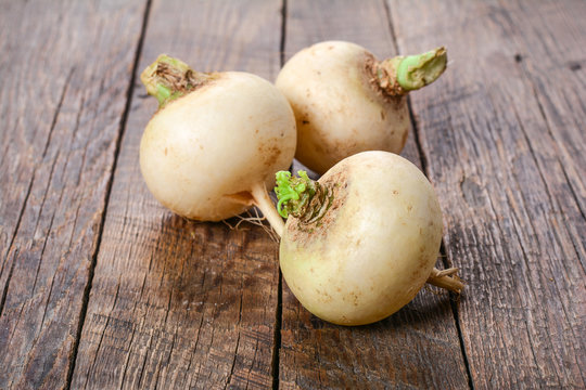 Fresh white radish on rustic wooden table,no GMO