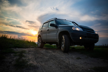 SUV with big wheels at sunset © diy13