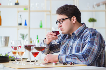 Professional sommelier tasting red wine 