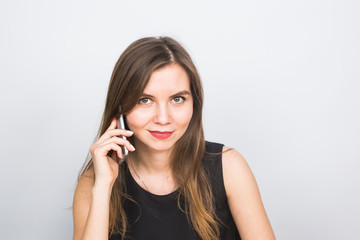 beautiful young woman speaks talking by mobile phone, on a white background