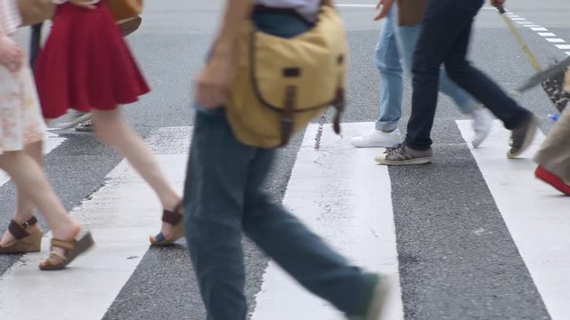People crossing the crosswalk. Crowded crosswalk. Urban Fukuoka city.
