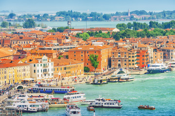 Fototapeta na wymiar Panoramic view of Venice from the Campanile tower of St. Mark's Cathedral (Campanile di San Marco)- seafront promenade near St. Mark's Square. Italy.