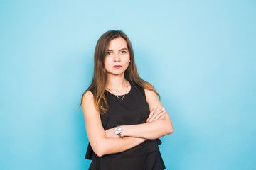 Fototapeta premium Young beautiful business woman or student against blue background.