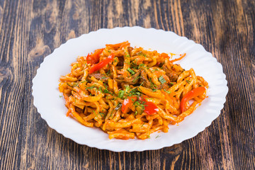 Traditional asian noodle lagman with vegetables and meat