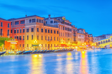 Views of the most beautiful canal of Venice - Grand Canal water streets, boats, gondolas, mansions along. Night view. Italy.