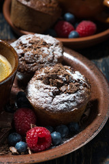 chocolate muffins and a cup of coffee, vertical closeup