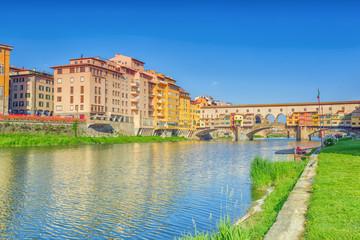 Fototapeta na wymiar Ponte Vecchio is a bridge in Florence, located at the narrowest point of the Arno River, almost opposite the Uffizi Gallery.Italy.