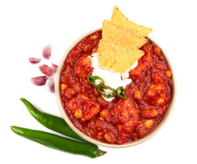 Bowl with delicious turkey chili on white background
