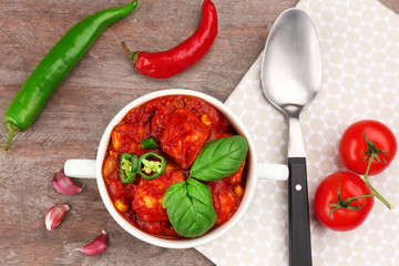 Casserole with delicious chili turkey on table