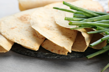Yummy unleavened tortillas on table