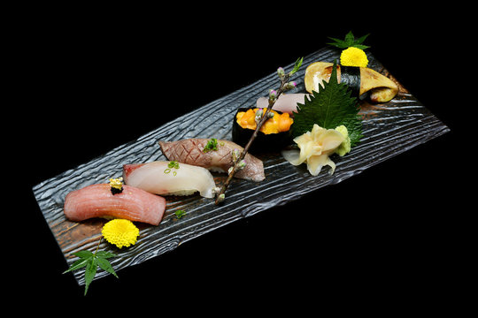 Japanese tradition food. Exclusive premium Sushi  set on wooden plate with black isolated background