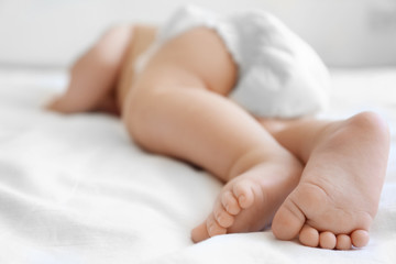 Cute little baby sleeping on bed at home