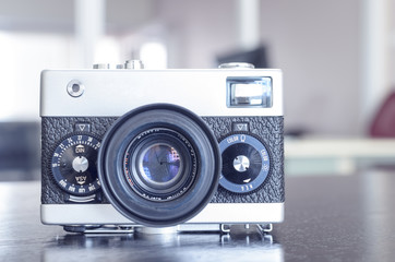 vintage manual rangefinder film camera in two-tone black&silver, shallow depth of field, filter effect