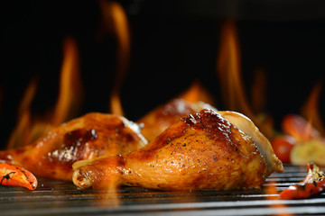 Grilled chicken leg on the flaming grill © amenic181