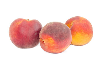 Three peaches on a white background