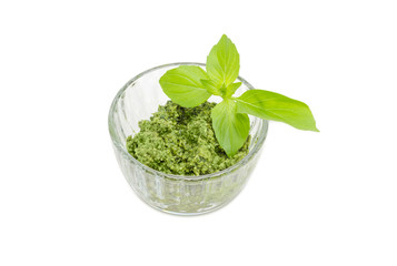 Pesto in the small glass bowl with basil twig