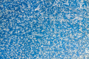 abstract blue  a white background from frosty pattern at a frosted window.