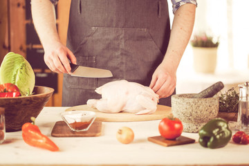 male preparing chicken for cooking