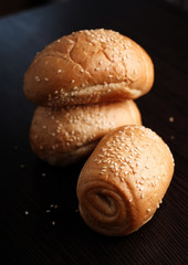 Wheat roll with sesame seeds on dark background